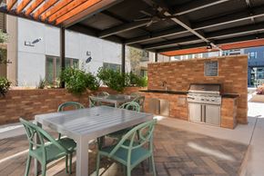 San Antonio apartment for rent - a patio with a table and chairs and an outdoor kitchen