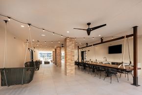 San Antonio apartment for rent - a dining room with a long table and chairs and a ceiling fan