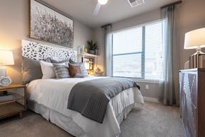 Glendale apartment for rent - A bedroom with a large bed and a painting above it.