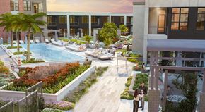 San Antonio apartment for rent - A pool surrounded by a small garden and a few people relaxing.