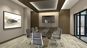 San Antonio apartment for rent - A conference room with a long table and chairs, a television, and a painting on the wall.