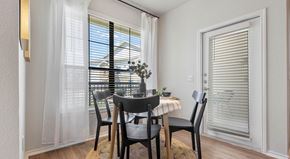Selma apartment for rent - a dining room with two windows and a door that leads to a balcony