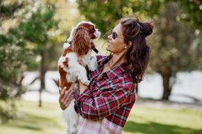 Spring Hill apartment for rent - A woman in a plaid shirt is holding a dog in her arms.