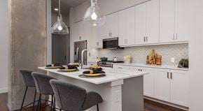 San Antonio apartment for rent - A kitchen with a table set for two with a white table cloth and two chairs.
