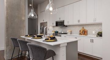 San Antonio apartment for rent - A kitchen with a table set for two with a white table cloth and two chairs.