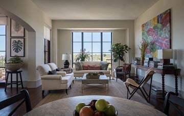 San Antonio apartment for rent - A living room with a table in the middle and a couch in the background.