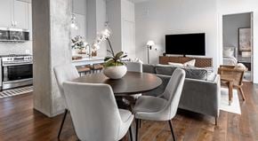 San Antonio apartment for rent - A modern dining room with a round table and white chairs.