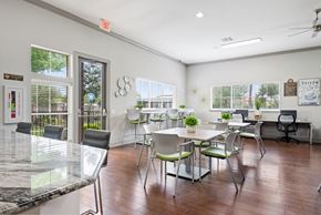 Houston apartment for rent - a dining room with tables and chairs and a bar and windows