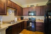 Bay City townhouse for rent - a kitchen with black appliances and wooden cabinets