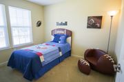 Bay City townhouse for rent - a bedroom with a bed and a football chair in it
