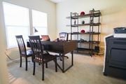 Bay City townhouse for rent - a dining room with a table and chairs and a desk with a laptop