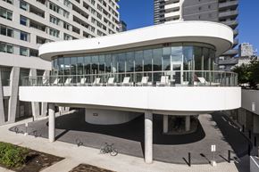 Toronto apartment for rent - A white circular building with a glass wall in the middle.