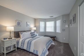 Westlake apartment for rent - the master bedroom has a large bed and windows