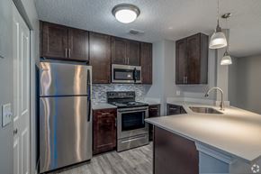 Westlake apartment for rent - an updated kitchen with stainless steel appliances and wooden cabinets