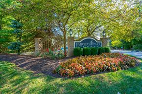 Copley apartment for rent - a sign for fairway park in front of trees and flowers