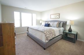 Uniontown apartment for rent - a bedroom with a bed and two windows