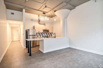 Cleveland apartment for rent - A kitchen area with a checkered table and a refrigerator.