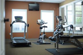 Copley apartment for rent - a gym with exercise equipment and a tv