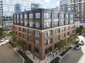 Chicago apartment for rent - A modern multi-story building with a glass facade on the top floor and brick facade on the bottom floor.