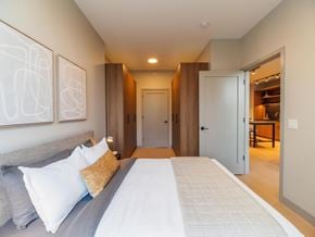 Chicago apartment for rent - a bedroom with a large bed and a door to a bathroom