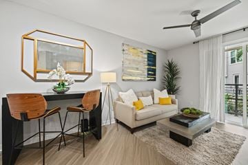 Orlando apartment for rent - A modern living room with a dining table and chairs.