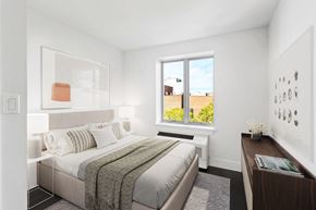 Brooklyn apartment for rent - a bedroom with a bed and a large window