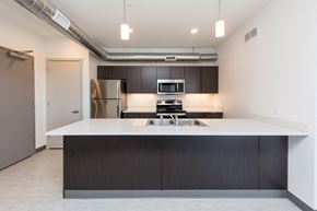 Des Moines apartment for rent - Modern open-concept kitchen and living area with stainless steel appliances.