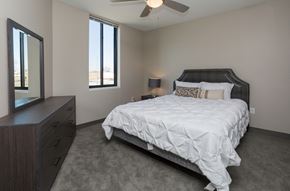 Des Moines apartment for rent - Bright, vacant bedroom with neutral walls and carpet flooring.