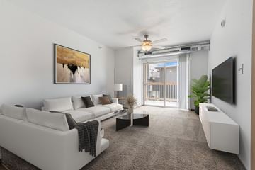 Sioux Falls townhouse for rent - A living room with a white couch and a painting on the wall.