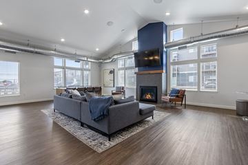 Harrisburg apartment for rent - A modern living room with a grey sofa and a fireplace.