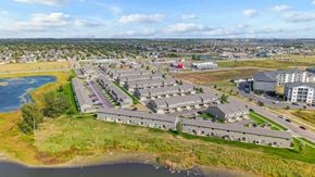 Sioux Falls townhouse for rent - A bird's eye view of a large building complex with a body of water in the foreground.