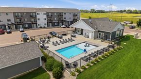 Harrisburg apartment for rent - A large apartment complex with a pool and a small house.