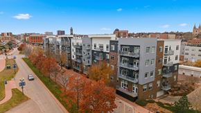 Sioux Falls apartment for rent - A street view of a residential area with apartment buildings and trees.