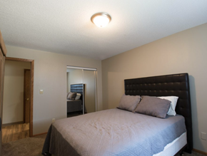 Sioux Falls apartment for rent - a bedroom with a bed and a door to a bathroom