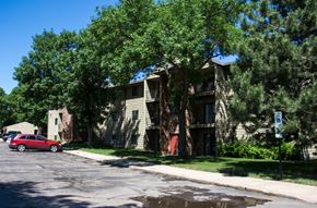 Sioux Falls apartment for rent - an apartment building with a red car parked in front of it