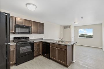 Rapid City apartment for rent - a kitchen with a sink and a stove and a refrigerator