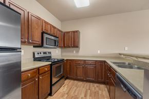 North Sioux City apartment for rent - A kitchen with wooden cabinets and stainless steel appliances.