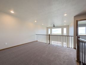 Sioux Falls townhouse for rent - the upstairs living room with a railing and a window