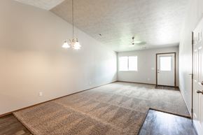 Harrisburg apartment for rent - an empty living room with a rug and white walls