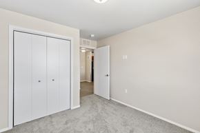 Rapid City apartment for rent - an empty bedroom with white closets and a carpeted floor