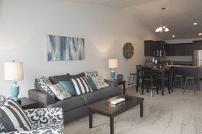 Sioux Falls townhouse for rent - a living room and dining room with a couch and a table