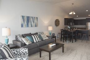 Sioux Falls townhouse for rent - a living room and dining room with a couch and a table