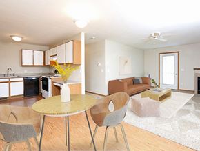 Tea apartment for rent - a living room and kitchen with a table and chairs