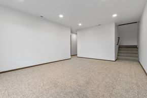 Sioux Falls apartment for rent - A spacious room with a staircase leading to another room.