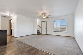 Harrisburg townhouse for rent - A spacious room with a ceiling fan and a large rug on the floor.