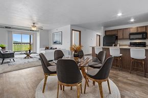 Sioux Falls apartment for rent - A modern dining room with a glass table and chairs.