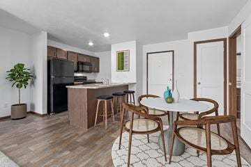Sioux Falls apartment for rent - A kitchen with a table and chairs in the middle of the room.