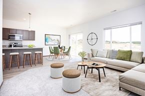 Sioux Falls apartment for rent - A modern living room with a bar area and a large window.