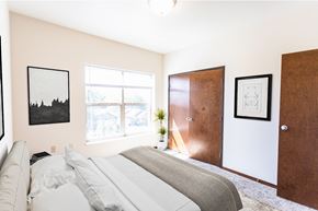 Sioux Falls apartment for rent - A bedroom with a bed, a window, and two pictures on the wall.