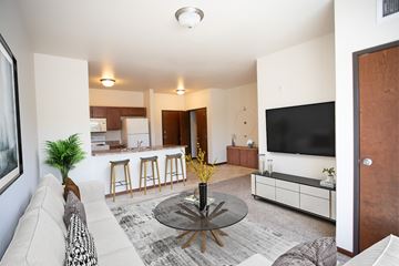 Sioux Falls apartment for rent - A living room with a white couch and a black coffee table.
